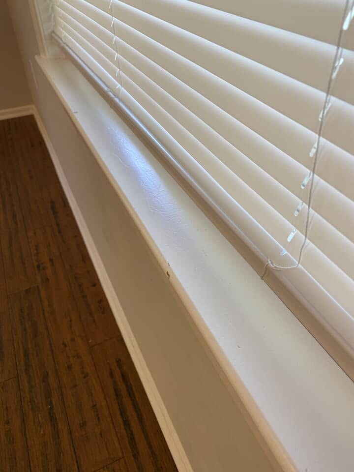 Dusted window sill and blinds